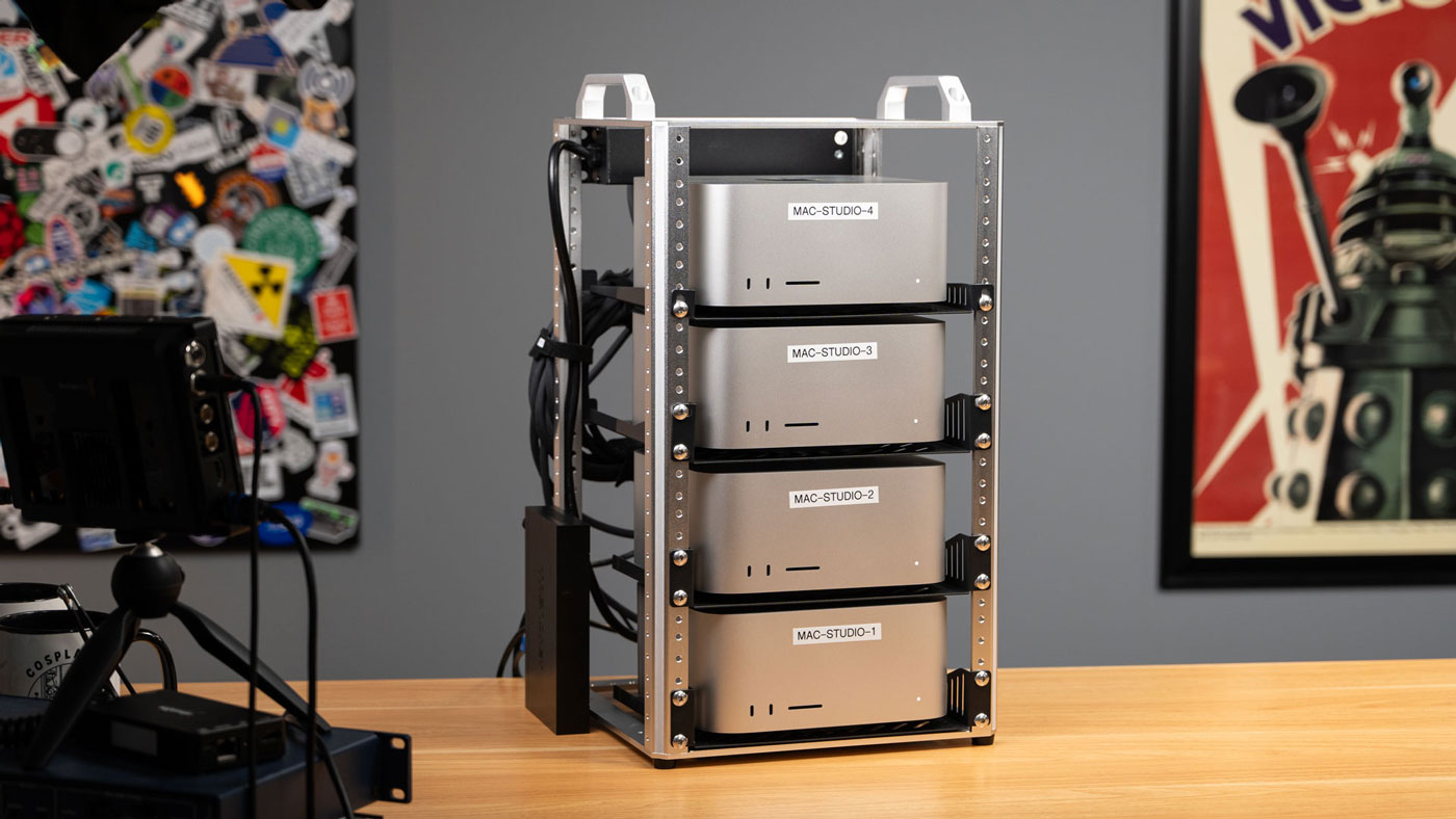 A stack of mac studios in a 10 inch rack. They appear networked from the back side.
