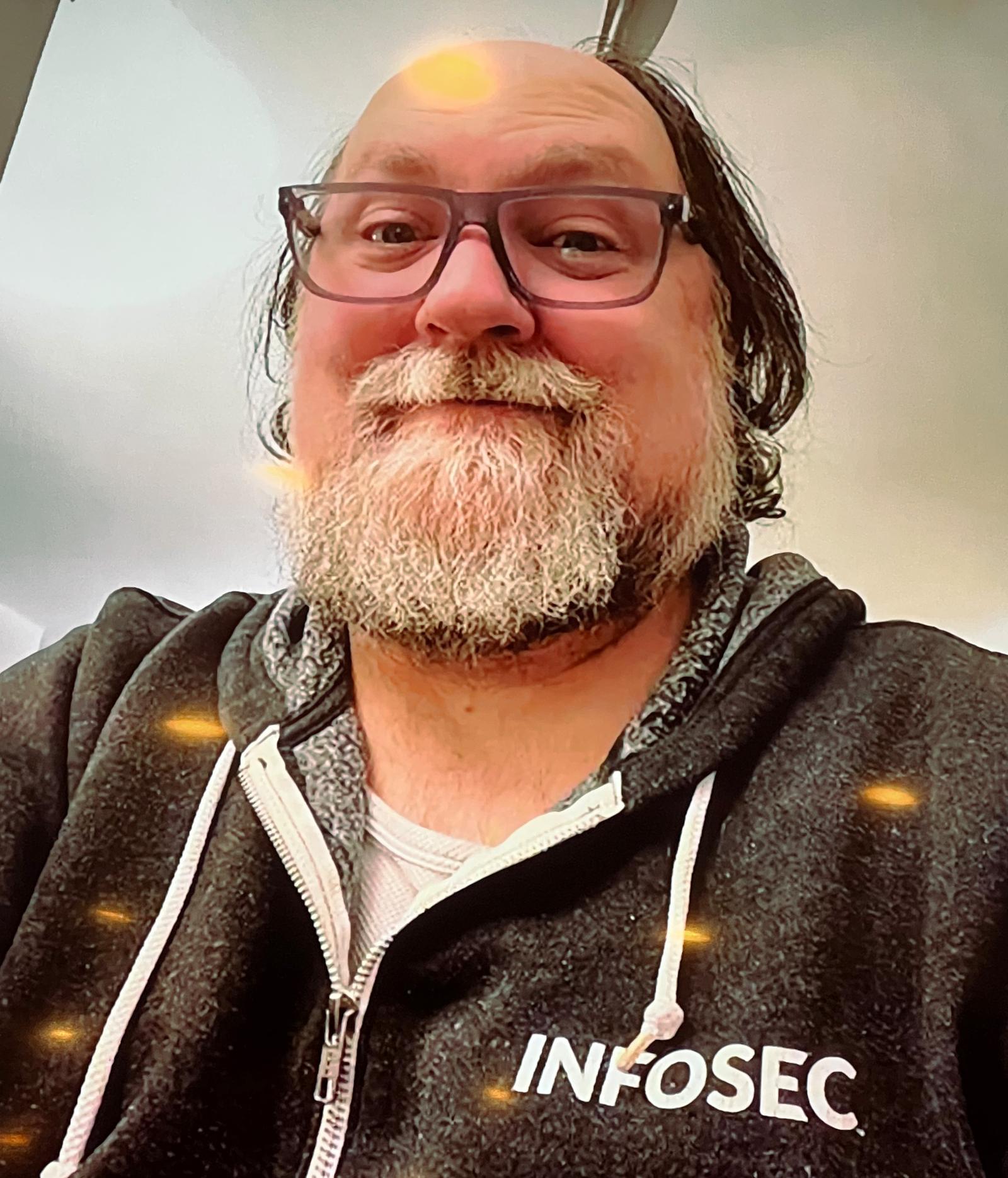 Erik wears a jacket with the INFOSEC brand on it.