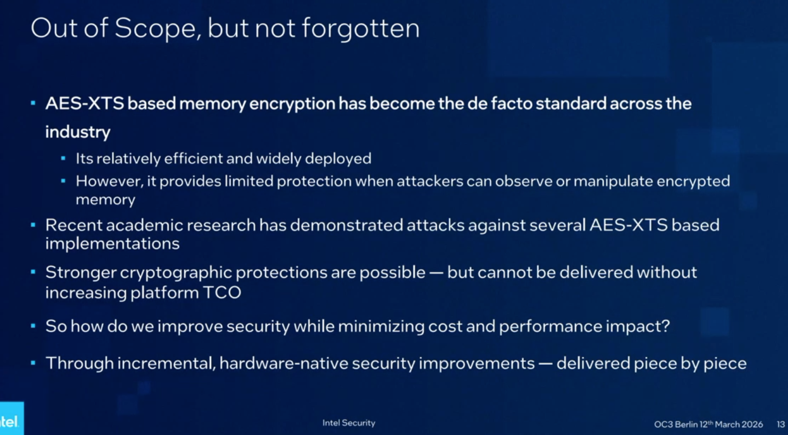 A presentation slide titled "Out of Scope, but not forgotten" displays white text on a dark blue background, listing points about AES-XTS based memory encryption. The text reads: "AES-XTS based memory encryption has become the de facto standard across the industry," followed by sub-points stating "Its relatively efficient and widely deployed" and "However, it provides limited protection when attackers can observe or manipulate encrypted memory." Further bullet points explain that "Recent academic research has demonstrated attacks against several AES-XTS based implementations" and "Stronger cryptographic protections are possible — but cannot be delivered without increasing platform TCO." The slide poses the question "So how do we improve security while minimizing cost and performance impact?" and answers "Through incremental, hardware-native security improvements — delivered piece by piece." The footer contains "Intel Security"